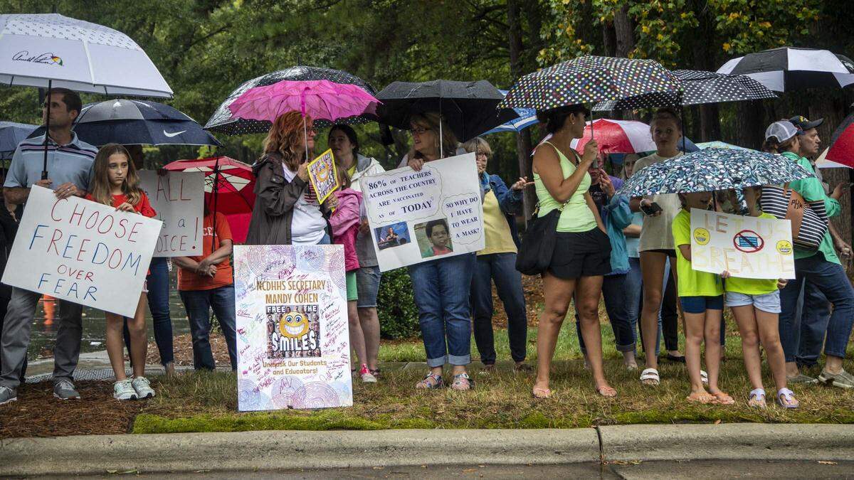 Protesters and counter-protesters demonstrate outside a Wake County Board of Education meeting Tuesday, Aug. 3, 2021 in Cary. The board will vote on a proposal to continue to require face masks in schools. Some parents argue the coverings should be optional.