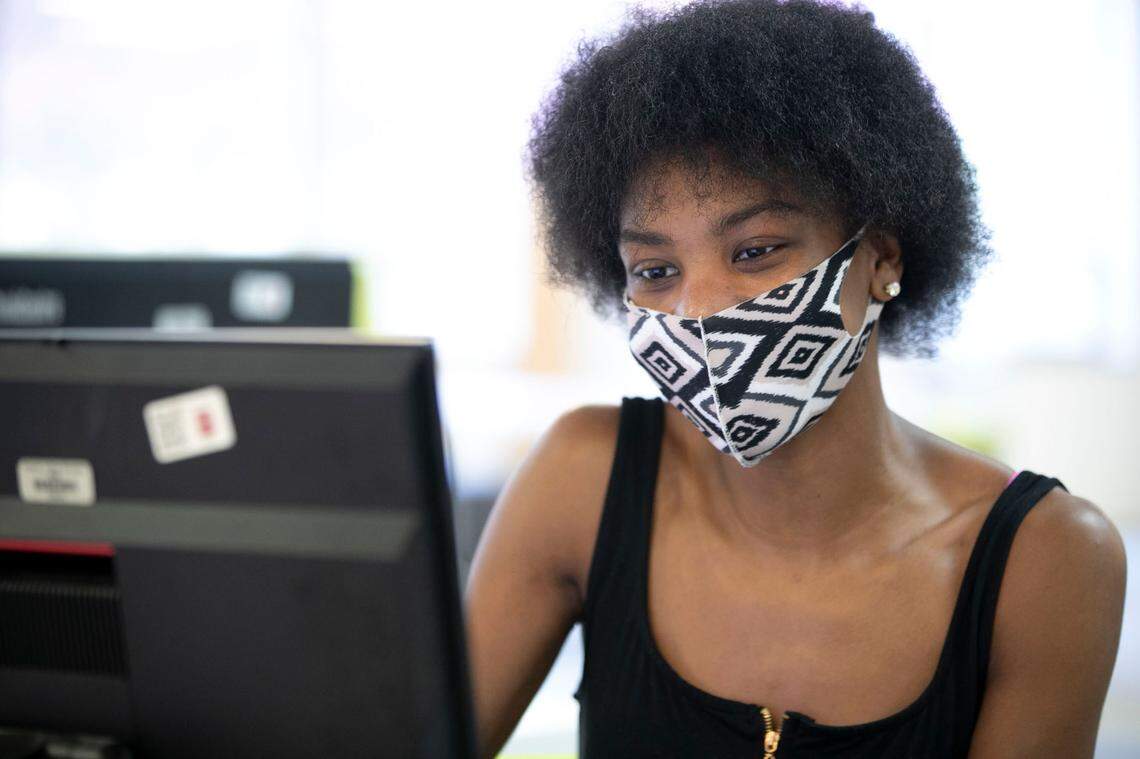 Lauryn Morris, a 5th-year Shaw University senior wears a face covering as he works on her schedule in the library on Tuesday, August 11, 2020 in Raleigh, N.C. Shaw will begin classes on August 12 amid the COVID-19 pandemic, with only about 50 percent of their student population on campus.