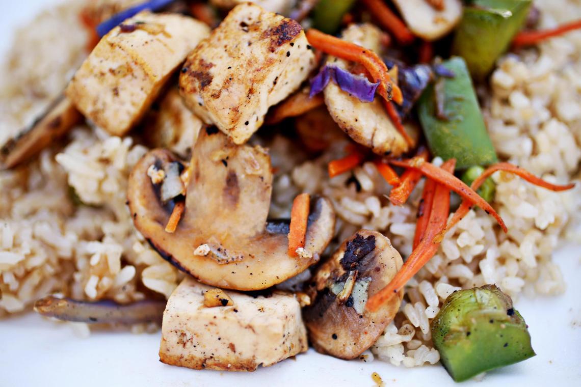 A medium bowl of tofu, cabbage, carrots, onions and green peppers is served over rice at Mr. Mongolian food truck in Durham.