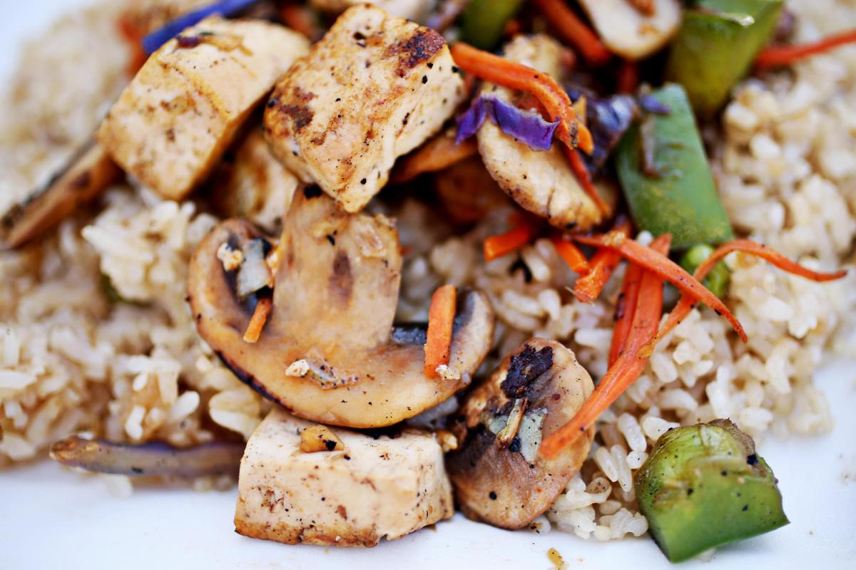 A medium bowl of tofu, cabbage, carrots, onions and green peppers is served over rice at Mr. Mongolian food truck in Durham.