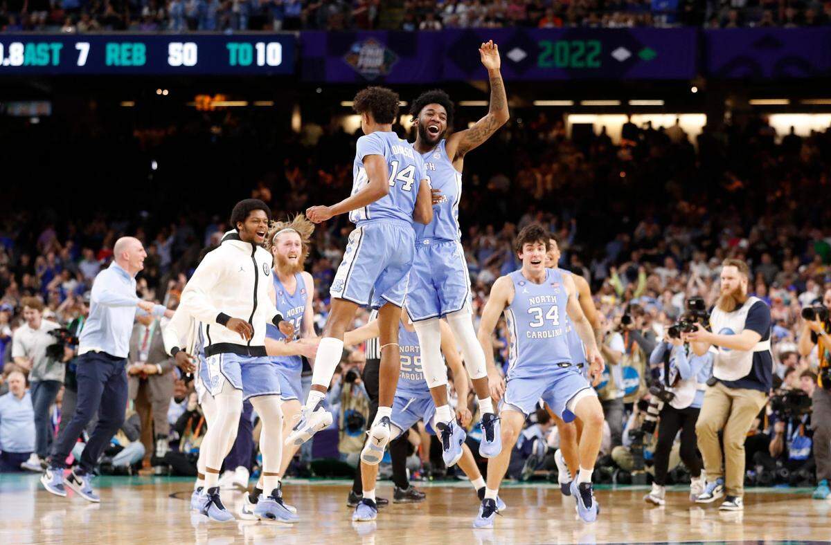 North Carolina's Dontrez Styles (3) and Puff Johnson (14) celebrate after UNC's 81-77 victory over Duke in the Final Four at Caesars Superdome in New Orleans, La., Saturday, April 2, 2022.