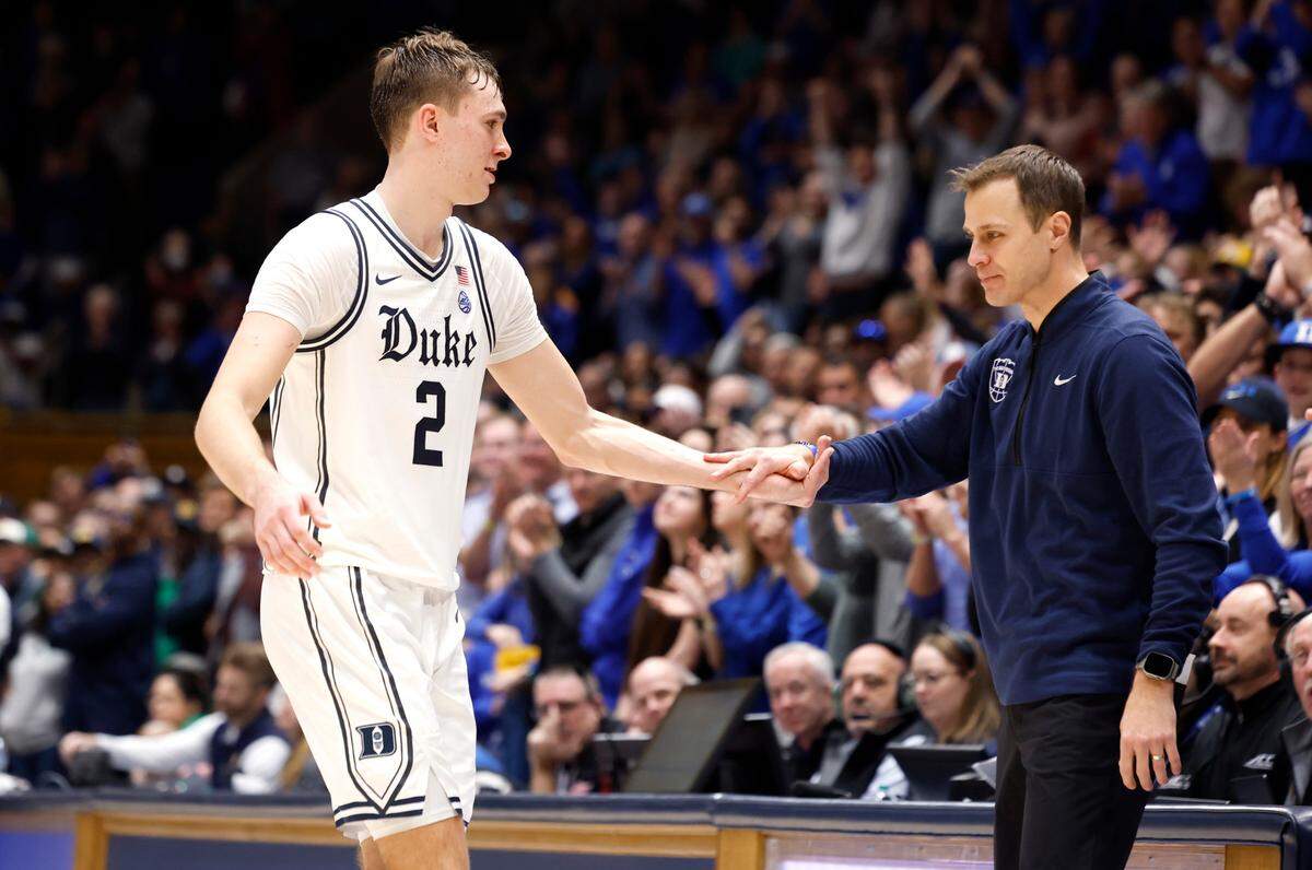 Duke head coach Jon Scheyer congratulates Cooper Flagg (2) as he comes out of the game with seconds left in Duke’s 86-78 victory over Notre Dame at Cameron Indoor Stadium in Durham, N.C., Saturday, Jan. 11, 2025.