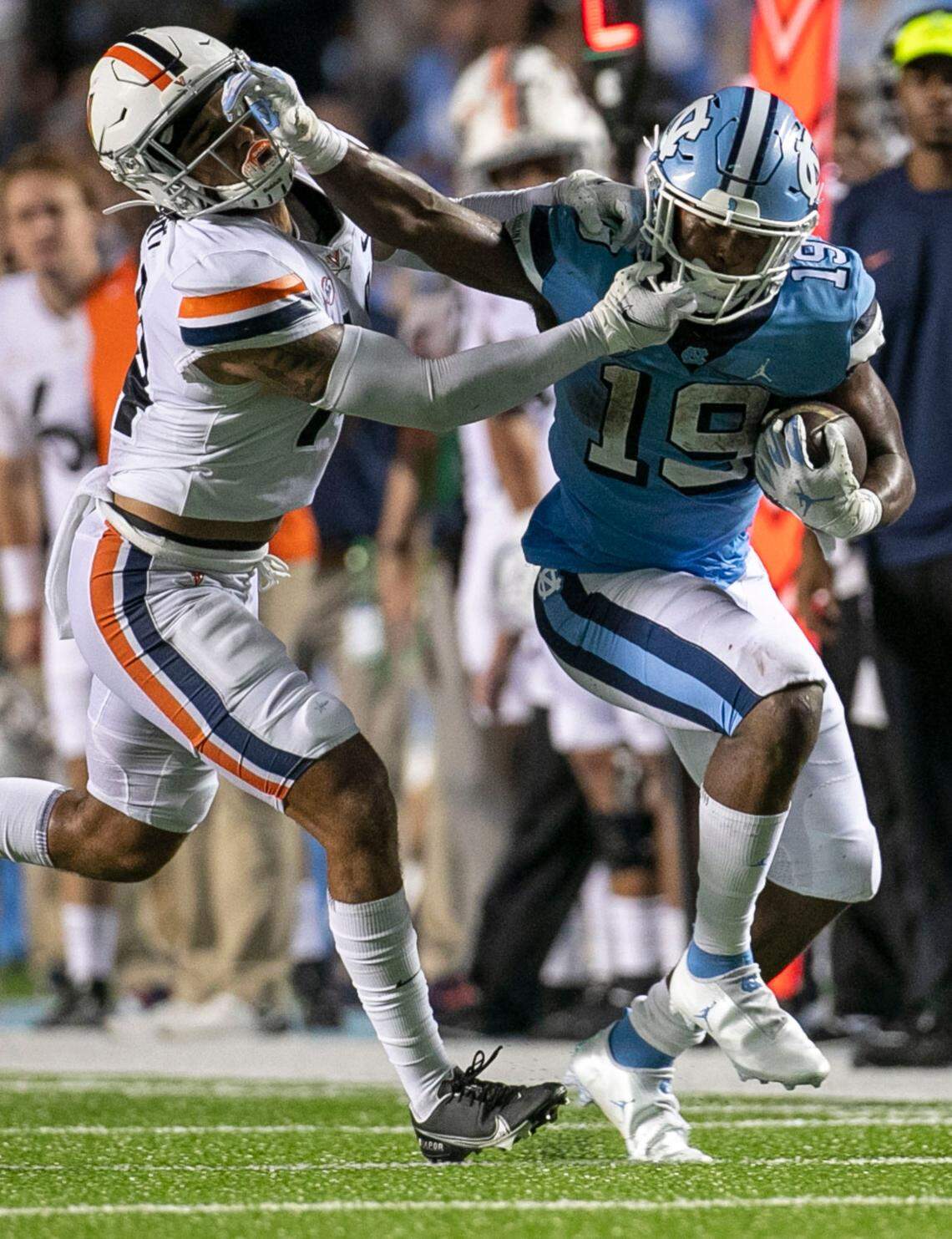 Virginia’s Elliott Brown (4) tries to stop North Carolina’s Ty Chandler (19) on a 21-yard run in the third quarter on Saturday, September 18, 2021 at Kenan Stadium in Chapel Hill, N.C. Brown was penalized for grabbing the face mask.