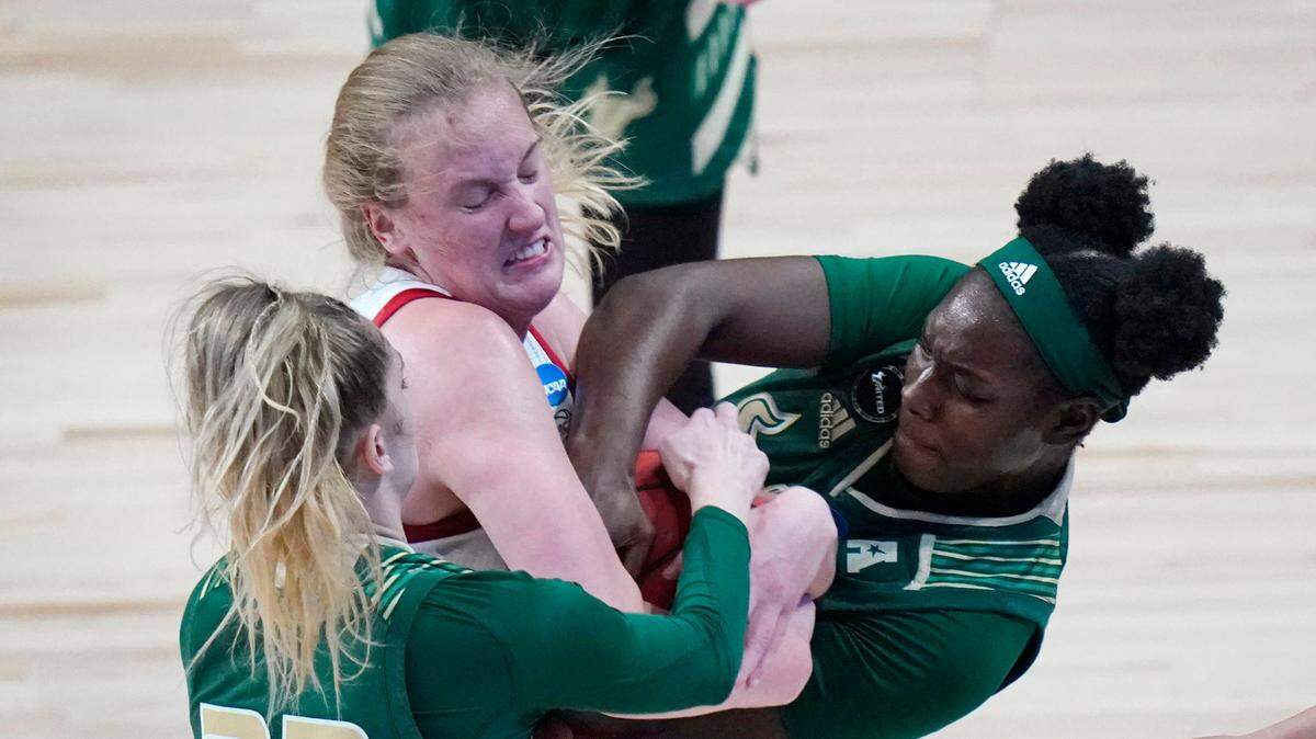 South Florida forward Kristyna Brabencova (22) and forward Bethy Mununga, right, fight for a loose ball with North Carolina State center Elissa Cunane during the first half of a college basketball game in the second round of the women’s NCAA tournament at the Alamodome in San Antonio, Tuesday, March 23, 2021.