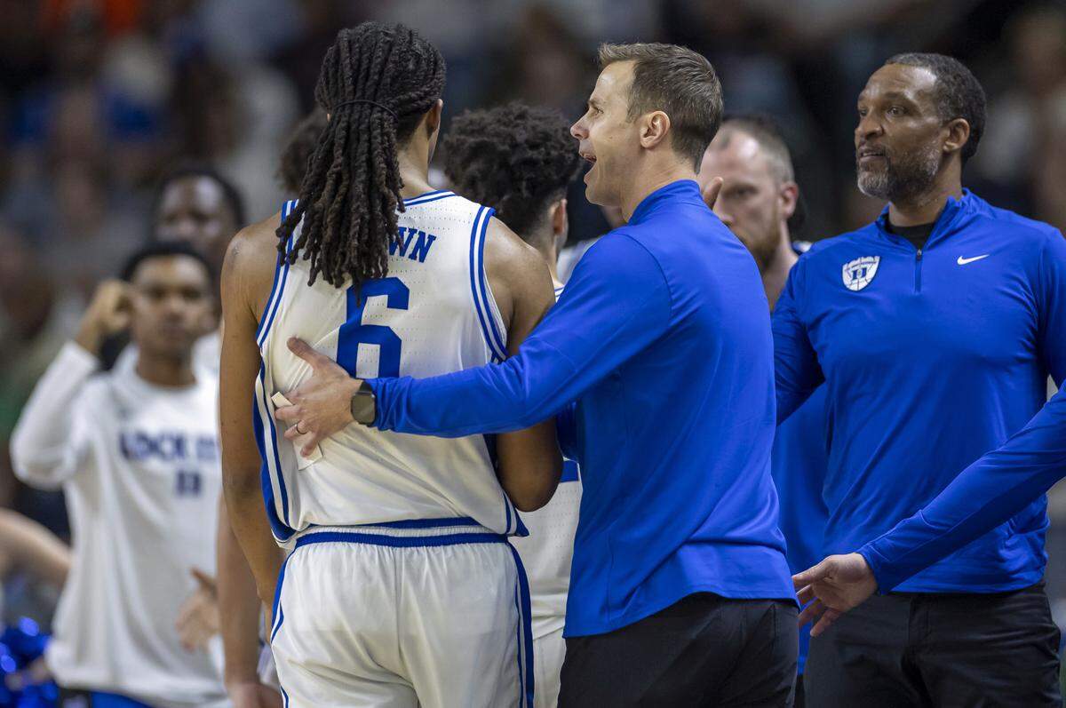 Duke coach Jon Scheyer embraces Maliq Brown (6) after taking him our of the game against TCU on Saturday, March 21, 2026, during the second round of the NCAA Tournament at Bon Secours Arena in Greenville, S.C. 