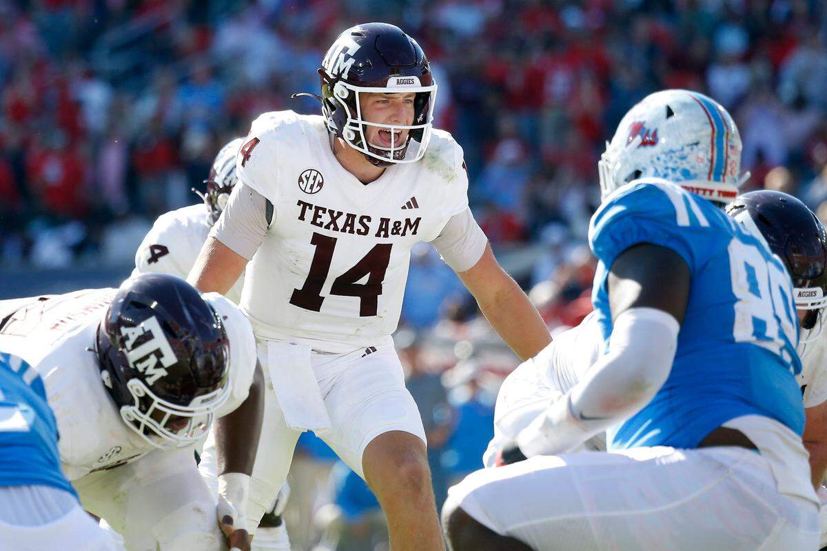 Nov 4, 2023; Oxford, Mississippi, USA; Texas A&M Aggies quarterback Max Johnson (14) gives direction prior to the snap during the second half against the Mississippi Rebels at Vaught-Hemingway Stadium. Mandatory Credit: Petre Thomas-USA TODAY Sports
