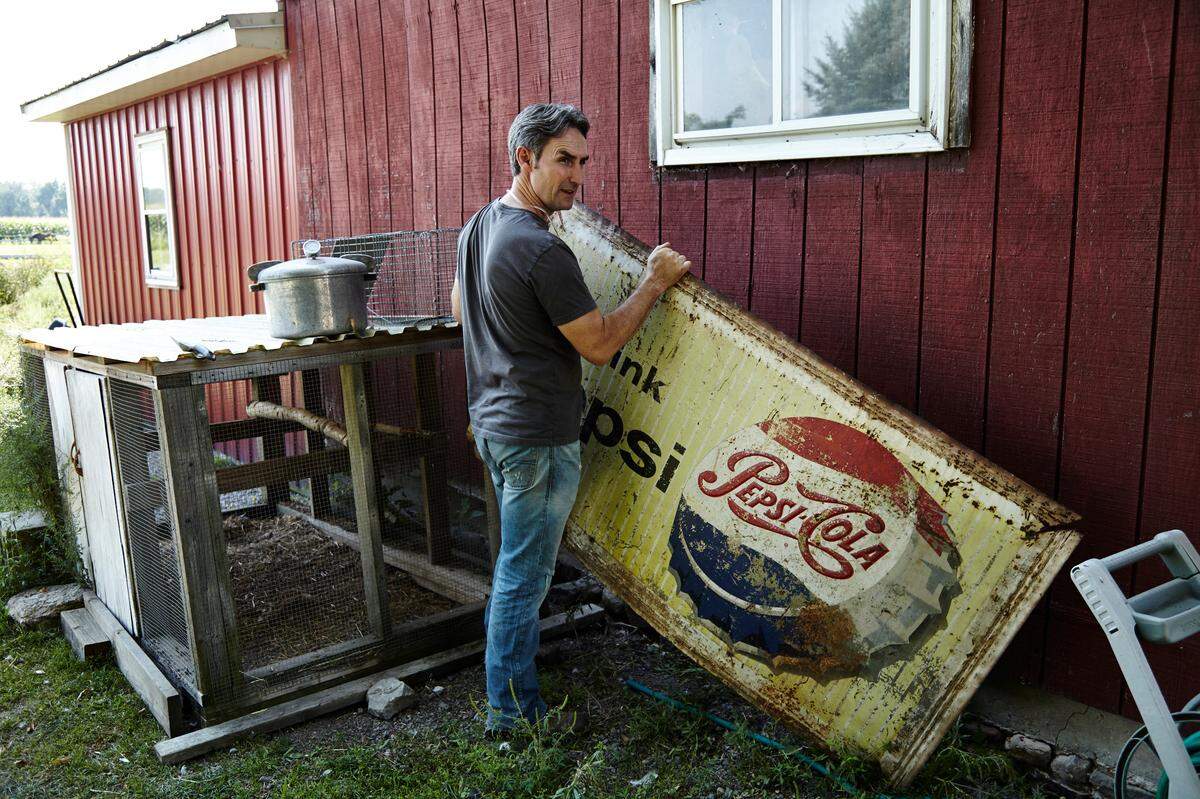 Mike Wolfe inspects an antique Pepsi sign for the History Channel TV show “American Pickers.”