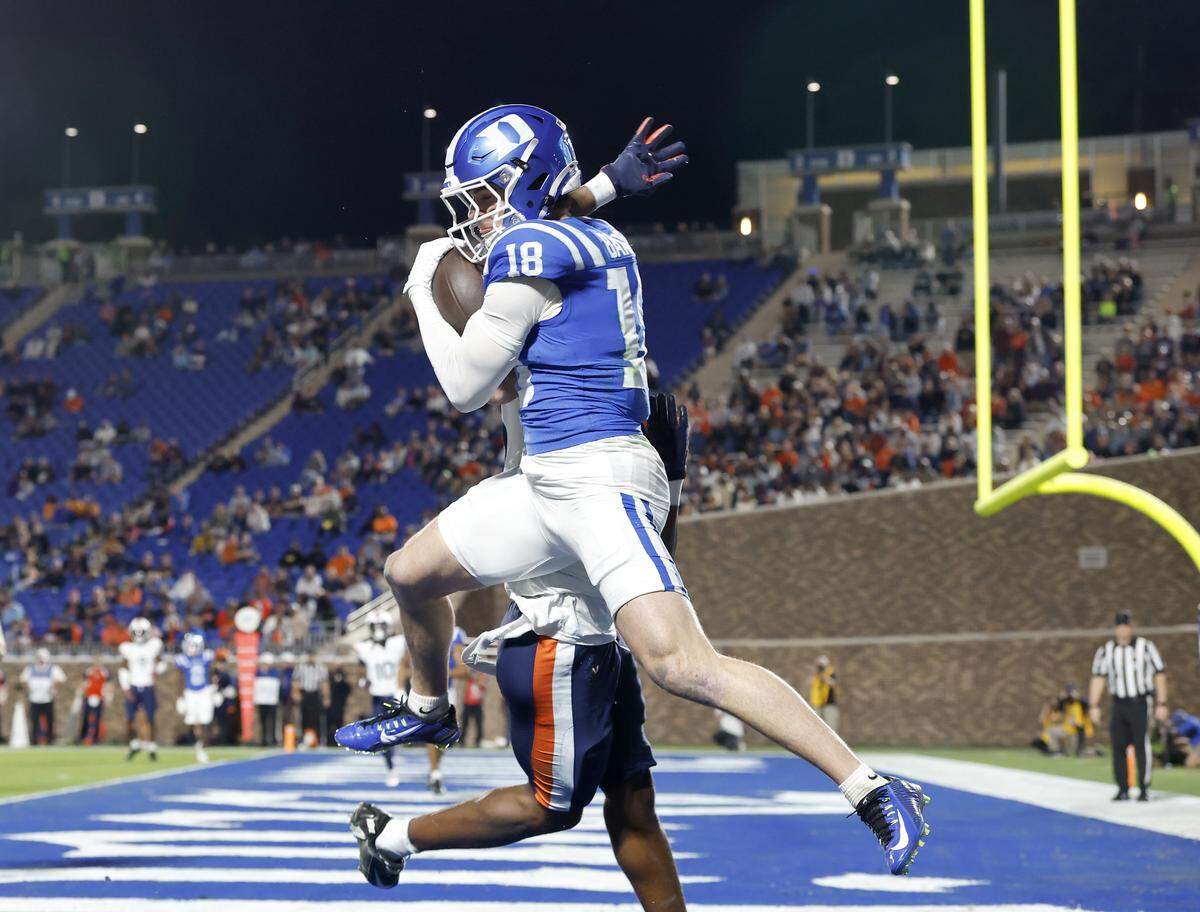 Duke wide receiver Cooper Barkate pulls in a pass over Virginia’s Emmanuel Karnley during the second half of the Blue Devils’ 34-17 loss on Saturday, Nov. 15, 2025, at Wallace Wade Stadium in Durham, N.C.
