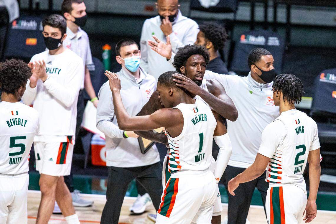 University of Miami center Nysier Brooks (3) embraces teammate forward Anthony Walker (1) after he scored against Duke forward Jalen Johnson (1) during a NCAA collegiate basketball game at the Watsco Center in Coral Gables, Florida, on Sunday, Feb. 1, 2021.