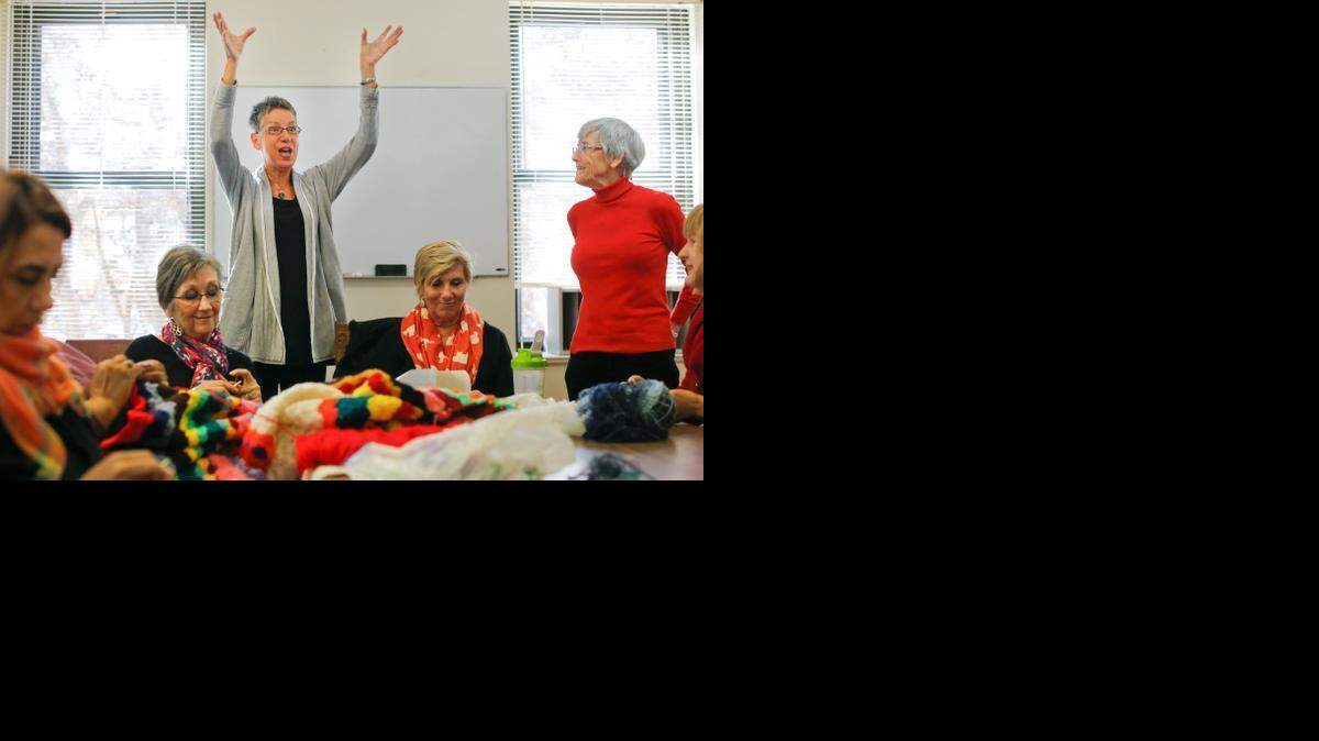 At Saint Saviour’s Center in Raleigh on Friday, Donna Belt talks to a knitting circle about plans to cover a large tree along Glenwood Avenue with a special patchwork sweater. After the project, the knitting will be turned into blankets for Love Wins Ministries.
