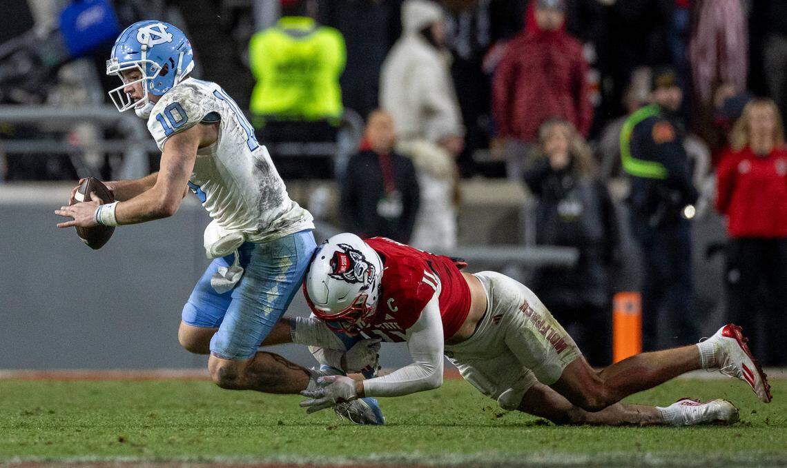 N.C. State’s Payton Wilson (11) sacks North Carolina quarterback Drake Maye (10) for a four-yard loss in the fourth quarter on Saturday, November 25, 2023 at Carter-Finley Stadium in Raleigh, N.