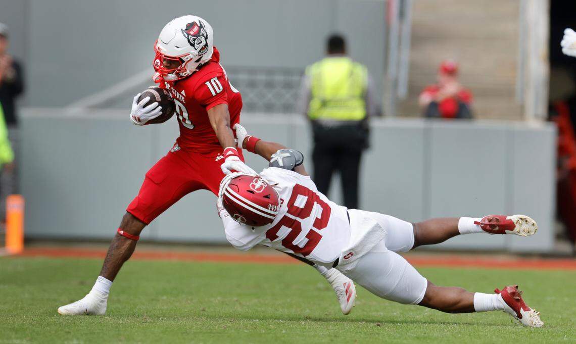 N.C. State wide receiver KC Concepcion (10) gains yards after a catch as Stanford safety Darrius Davis (29) tries to tackle him during the first half of N.C. State’s game against Stanford at Carter-Finley Stadium in Raleigh, N.C., Saturday, Nov. 2, 2024.