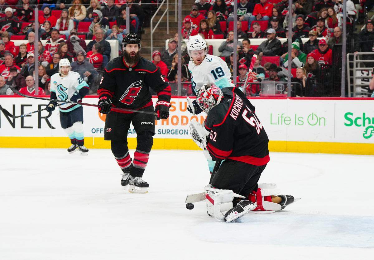 Carolina Hurricanes goaltender Pyotr Kochetkov (52) makes a save in front of Seattle Kraken left wing Jared McCann (19) during the second period at Lenovo Center.
