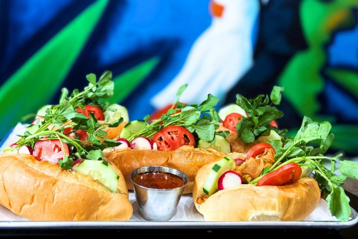 Pan con Pollo, a Salvadoran sandwich made with stewed chicken, fresh vegetables, pickles, and a special sauce, is found on the menu at The Latin Effect in Chapel Hill, NC.