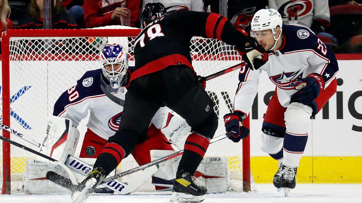 Carolina Hurricanes’ Steven Lorentz (78) tries to shoot the puck past Columbus Blue Jackets goaltender J-F Berube (30) with Blue Jackets’ Brendan Gaunce (23) nearby during the first period of an NHL hockey game in Raleigh, N.C., Friday, Feb. 25, 2022. (AP Photo/Karl B DeBlaker)