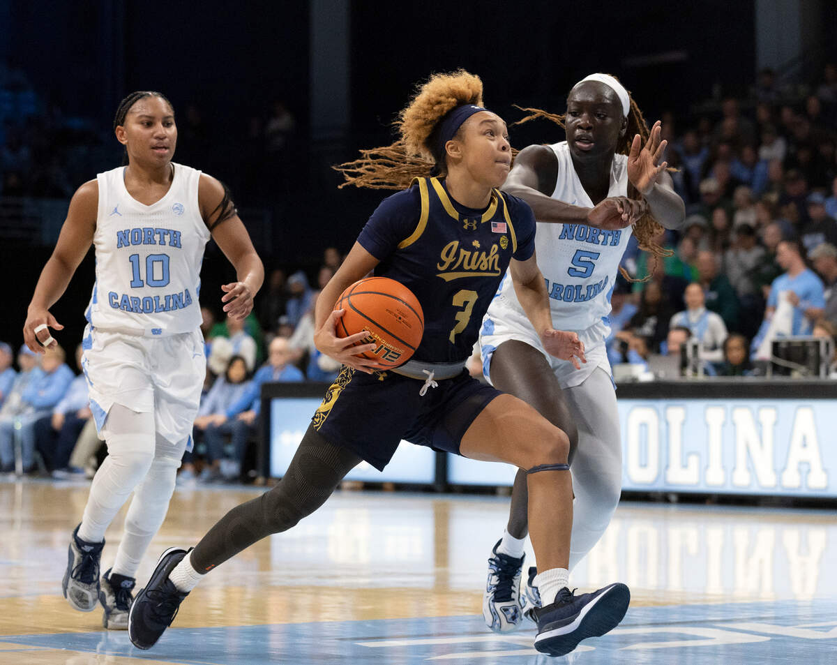 Notre Dame’s Hannah Hidalgo drives past North Carolina’s Reniya Kelly and Maria Gakdeng during the second half of the Tar Heels’ 76-66 loss on Sunday, Jan. 5, 2025, at Carmichael Arena in Chapel Hill, N.C.