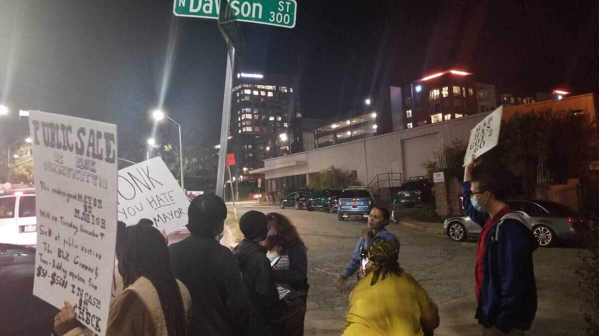Demonstrators stood outside an Italian restaurant on Dawson Street on Tuesday night, Nov 9, 2021, to protest Raleigh Mayor Mary-Ann Baldwin’s bid for a second term as mayor, blaming her for gentrification.
