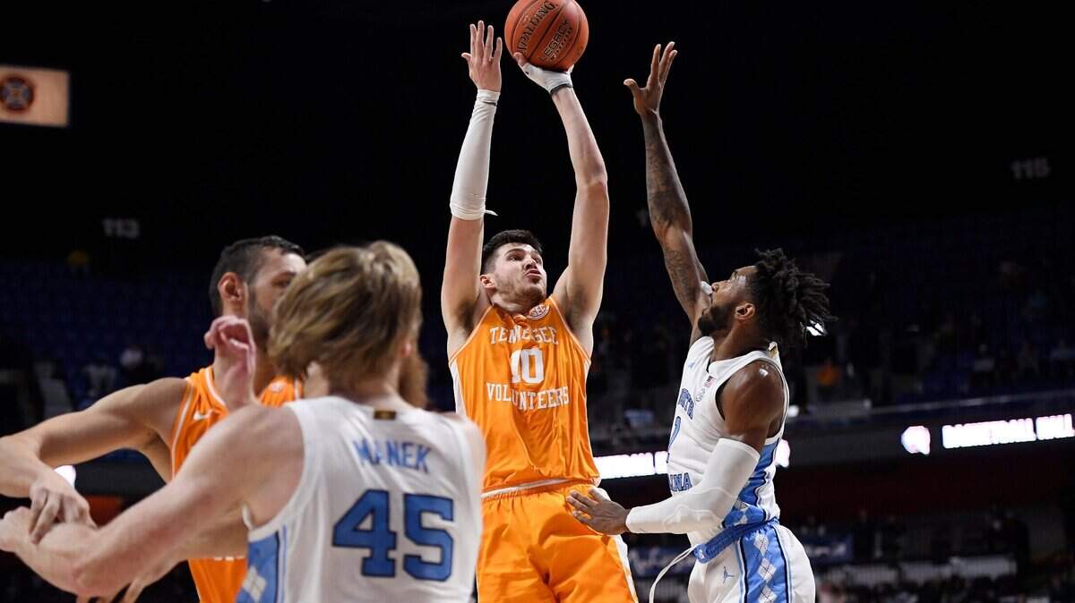 Tennessee’s John Fulkerson (10) shoots over North Carolina’s Caleb Love (2) in the first half of an NCAA college basketball game, Sunday, Nov. 21, 2021, in Uncasville, Conn. (AP Photo/Jessica Hill)