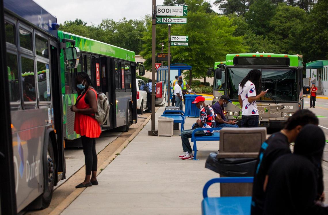 Passengers and bus drivers prepare to board their buses at the GoTriangle Regional Transit Center, on Monday, June 7, 2021, in Durham, N.C.