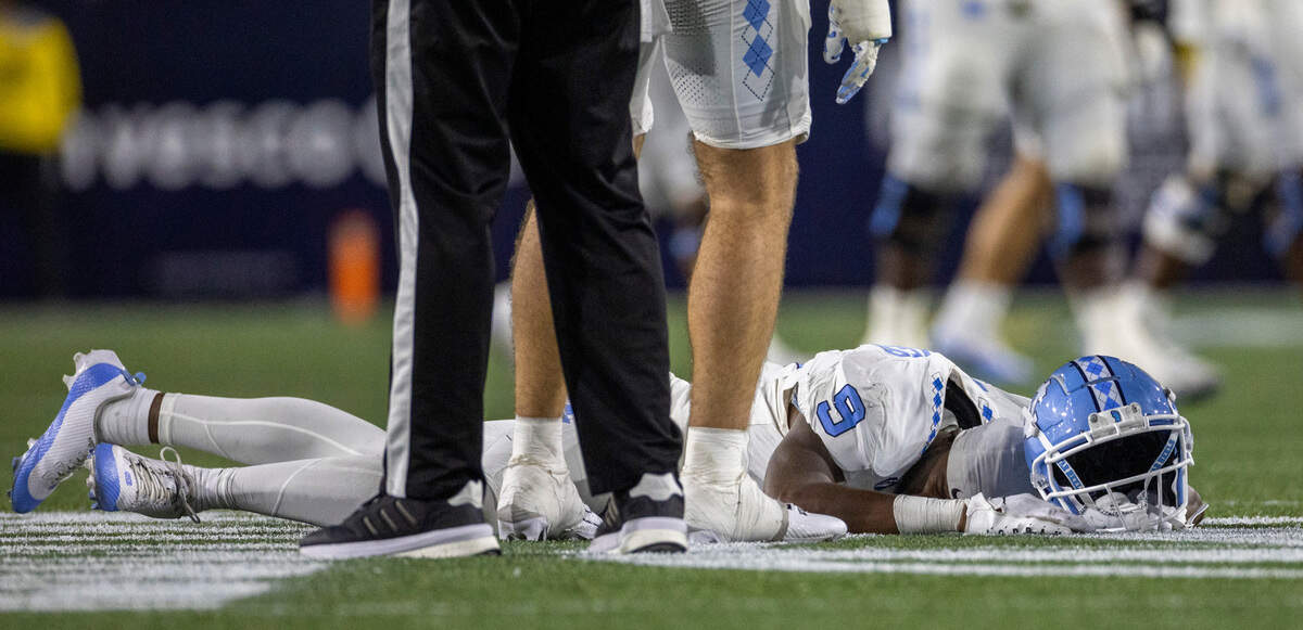 North Carolina’s Devontez Walker (9) lies on the turf after taking a hit from Georgia Tech’s Kyle Efford (44) and Ahmari Harvey (18) in the fourth quarter on Saturday, October 28, 2023 at Bobby Dodd Stadium in Atlanta, Georgia.