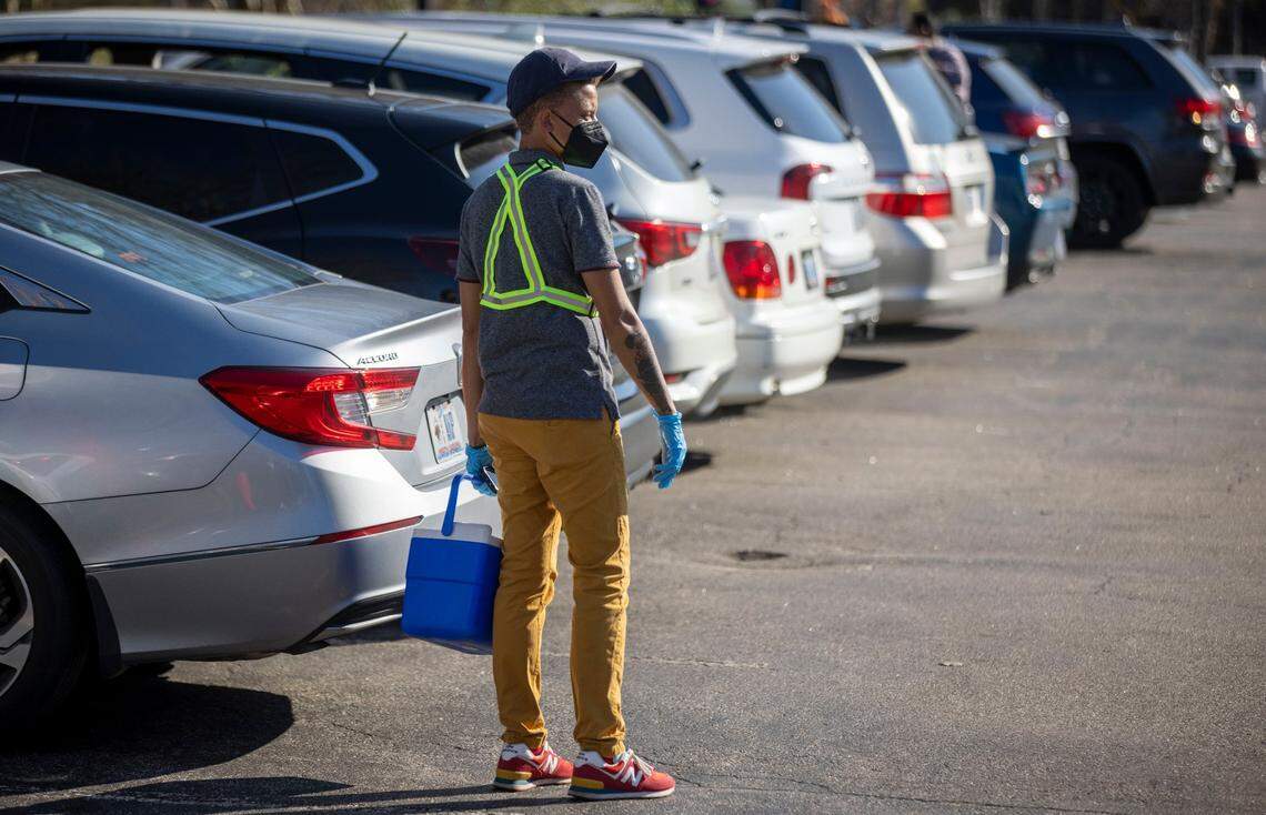 Staff at the Wake County COVID-19 testing site on Departure Drive wait to collects test samples from clients on Tuesday, December 28, 2021 in Raleigh, N.C. The rapid spread of the omicron variant combined with the Christmas Holiday, has increased the demand for testing.
