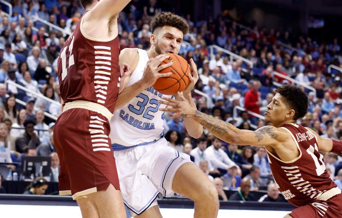 North Carolina’s Pete Nance (32) drives by Boston College’s Quinten Post (12) and Makai Ashton-Langford (11) during the first half of UNC’s game against Boston College in the second round of the New York Life ACC Men’s Basketball Tournament in Greensboro, N.C., Wednesday, March 8, 2023.