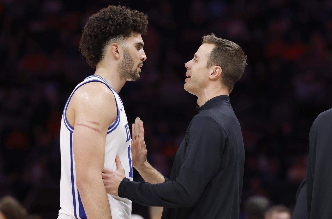 Duke head coach Jon Scheyer talks to Cameron Boozer (12) during the second half of Duke’s 73-61 victory over Clemson in the semifinals of the 2026 ACC Men’s Basketball Tournament at the Spectrum Center in Charlotte, N.C., Friday, March 13, 2026.