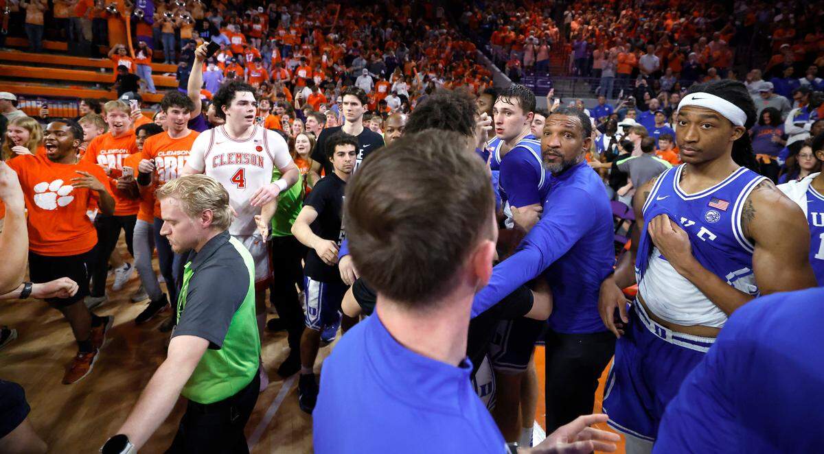 Duke watches as fans storm the court as they look for a way off the floor after Clemson’s 77-71 victory at Littlejohn Coliseum in Clemson, S.C., Saturday, Feb. 8, 2025.