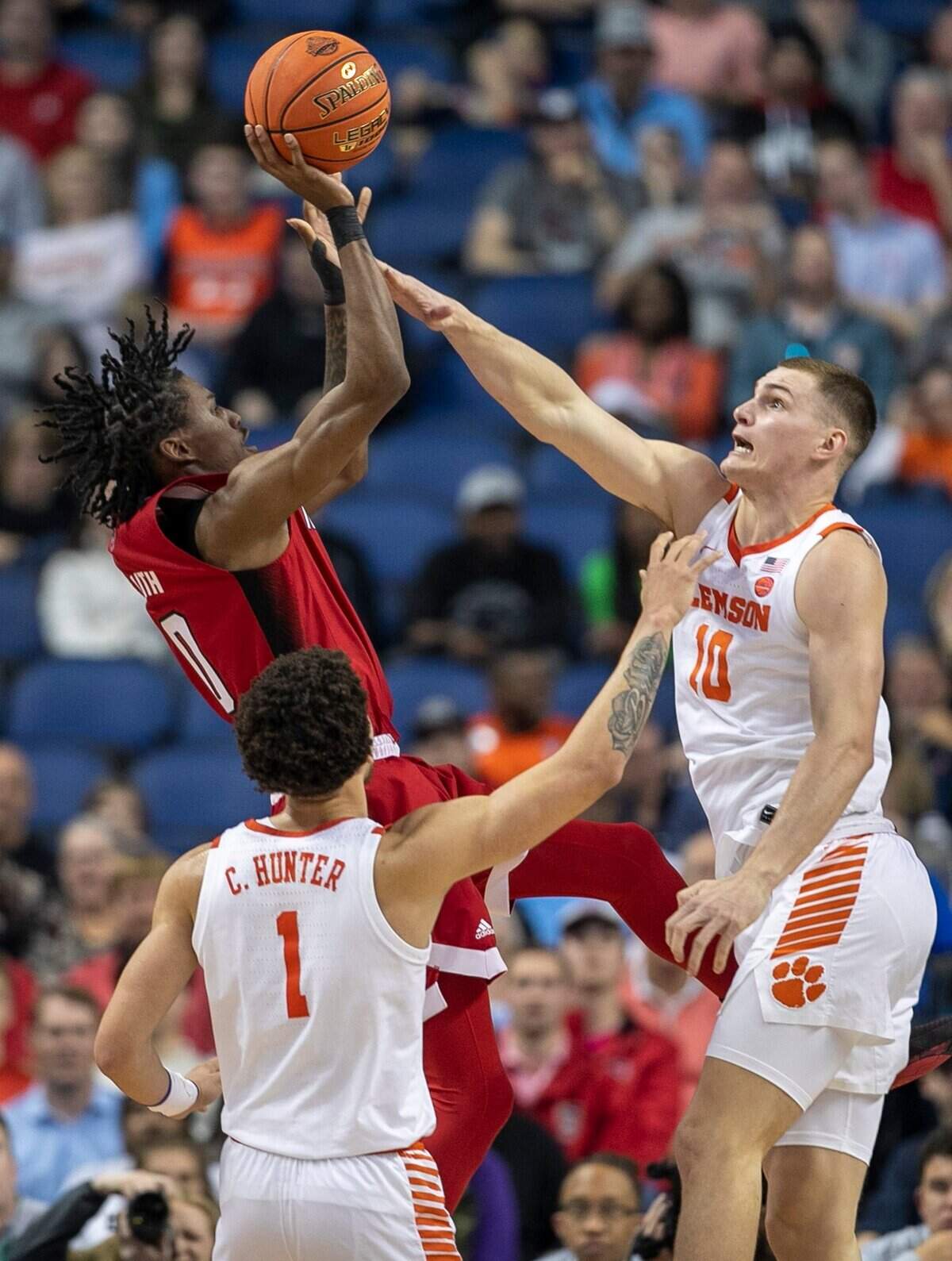 Clemson’s Ben Middlebrooks (10) and Josh Beadle (0) Chase Hunter (1) defend N.C. State’s Terquavion Smith (0) in the first half during the third round of the ACC Tournament on Thursday, March 9, 2023 at the Greensboro Coliseum in Greensboro, N.C.