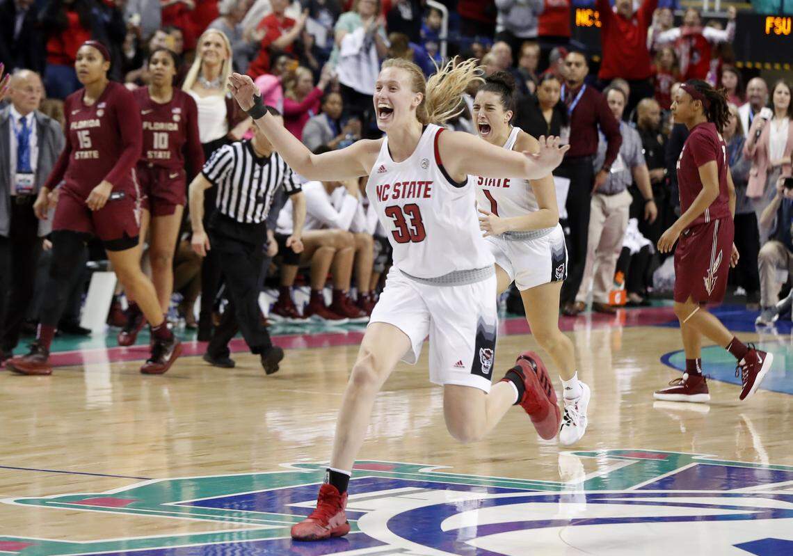 N.C. State’s Elissa Cunane (33) and Aislinn Konig (1) head to their teammates after the N.C. State Wolfpack’s 71-66 victory over the Florida State Seminoles in the ACC Tournament finals at Greensboro Coliseum in Greensboro, N.C., Sunday, March 8, 2020.