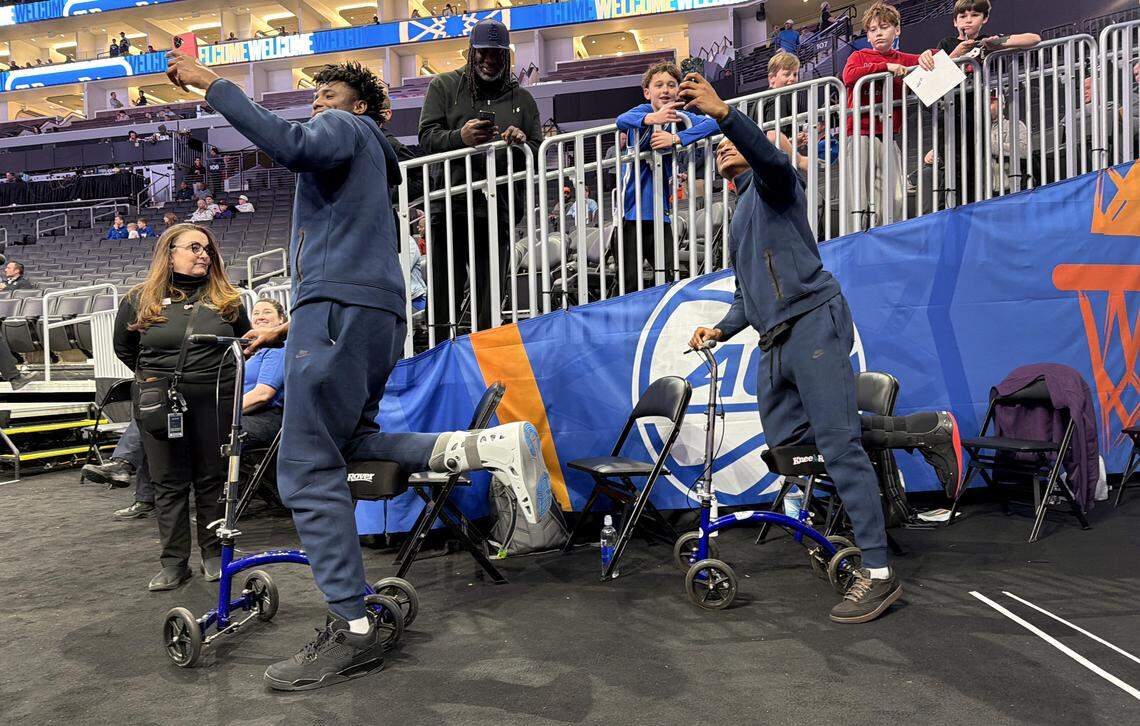 Duke’s Patrick Ngongba II and Caleb Foster take selfies with fans before Duke’s game against Florida State in the quarterfinals of the 2026 ACC Men’s Basketball Tournament at the Spectrum Center in Charlotte, N.C., Thursday, March 12, 2026.