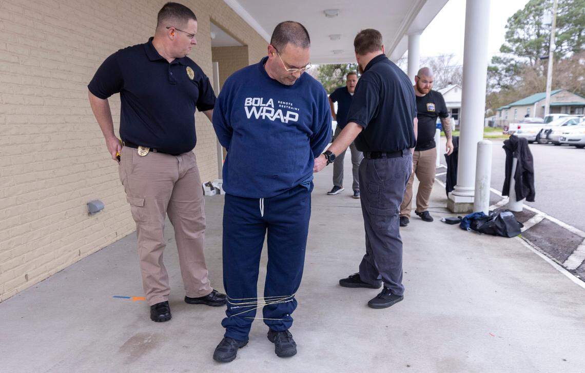 Edenton police officers train with BolaWrap, a restraint device that police departments across the country are trying. Edenton was the first department to use BolaWrap in North Carolina in 2019.