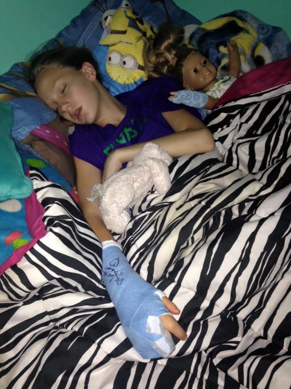 Riley Heitz as a child, comforted by the Beanie Baby that saw her through neonatal intensive care.