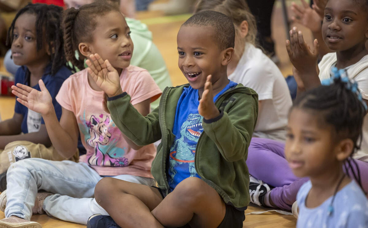 Kindergarten student Darrius Brown and his classmates at Green Magnet Elementary School show their excitement as they are told the school will be receiving free bicycles.