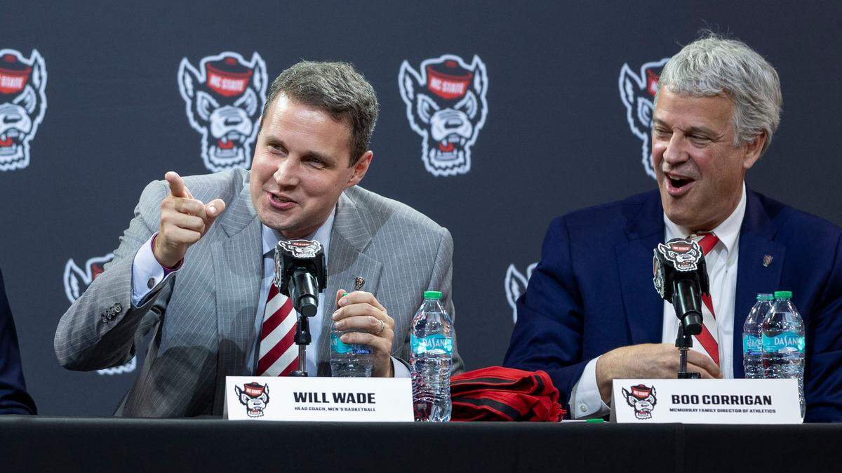 Will Wade, center, flanked by N.C. State Chancellor Randy Woodson and athletic director Boo Corrigan field questions following his introduction at the new Wolfpack men’s basketball coach on Tuesday, March 25, 2025 at Reynolds Coliseum in Raleigh, N.C.