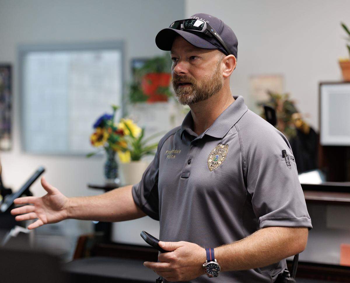 Knightdale Police Sgt. Rod Glahn talks with a law enforcement colleague at Knightdale High School on Wednesday, Aug. 13, 2025. 