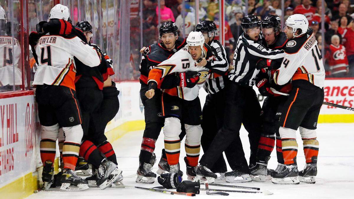 Carolina Hurricanes’ Brett Pesce (22) ties up Anaheim Ducks’ Ryan Getzlaf (15) in the middle of other players having an altercation during the second period of an NHL hockey game in Raleigh, N.C., Sunday, April 10, 2022. (AP Photo/Karl B DeBlaker)