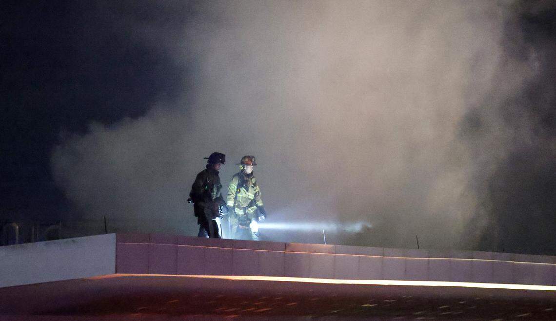 Firefighters work on the roof at the Raleigh Convention Center in downtown Raleigh, N.C., Monday evening, Dec. 1, 2025.