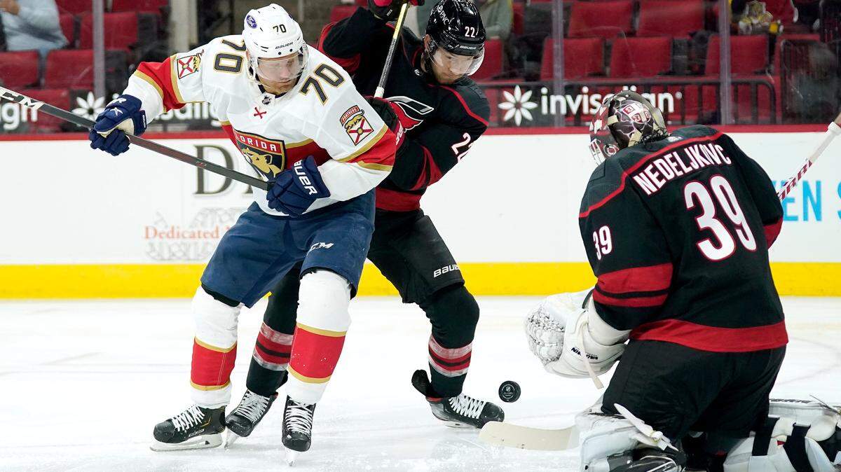 Florida Panthers right wing Patric Hornqvist (70) tries to get a shot against Carolina Hurricanes goaltender Alex Nedeljkovic (39) while Hurricanes’ Brett Pesce (22) defends during the first period of an NHL hockey game in Raleigh, N.C., Thursday, April 8, 2021. (AP Photo/Gerry Broome)