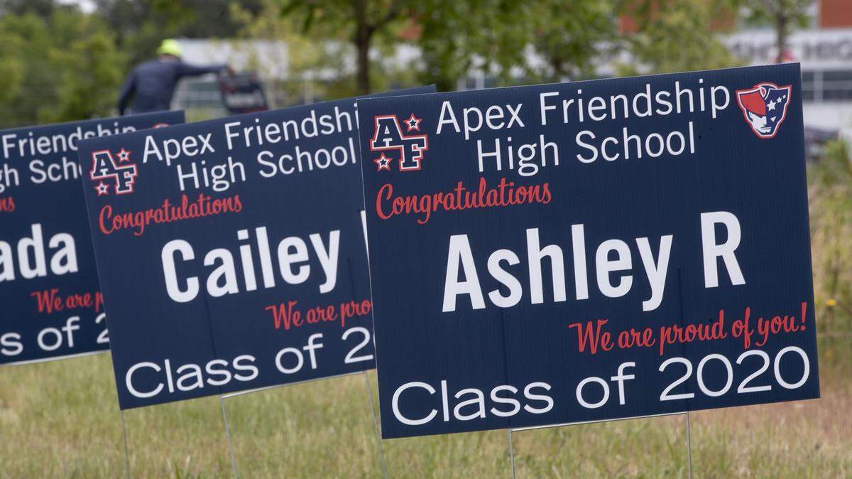 When Apex Friendship High School seniors arrived to pick up their caps and gowns on Tuesday, May 5, 2020 in Apex, N,C., they found a yard sign with each graduate’s name lining the entrance to the school.