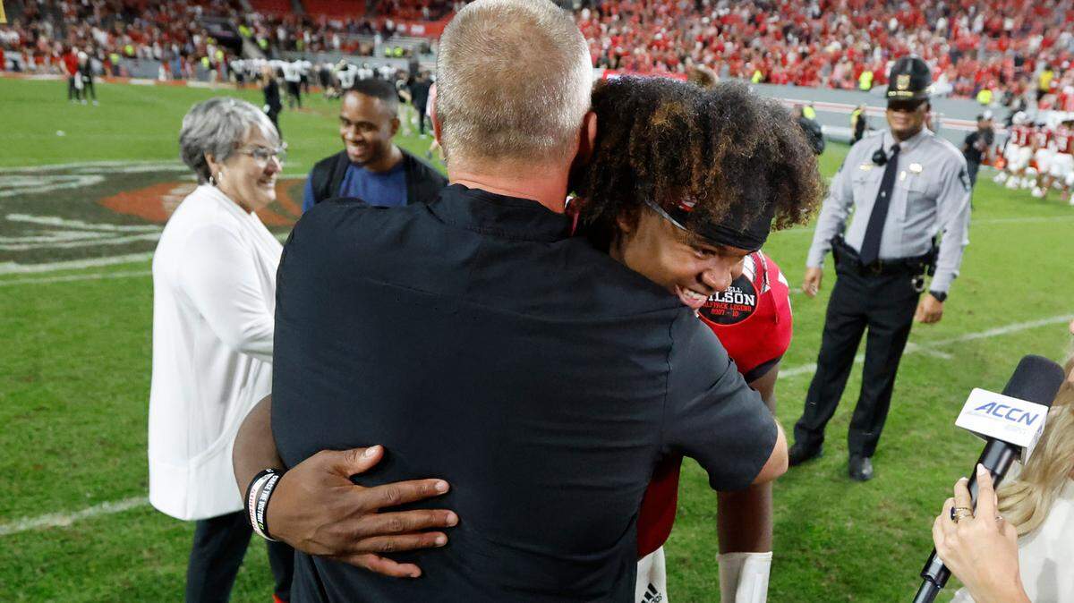 N.C. State head coach Dave Doeren hugs quarterback MJ Morris (16) after N.C. State’s 30-21 victory over Wake Forest at Carter-Finley Stadium in Raleigh, N.C., Saturday, Nov. 5, 2022.