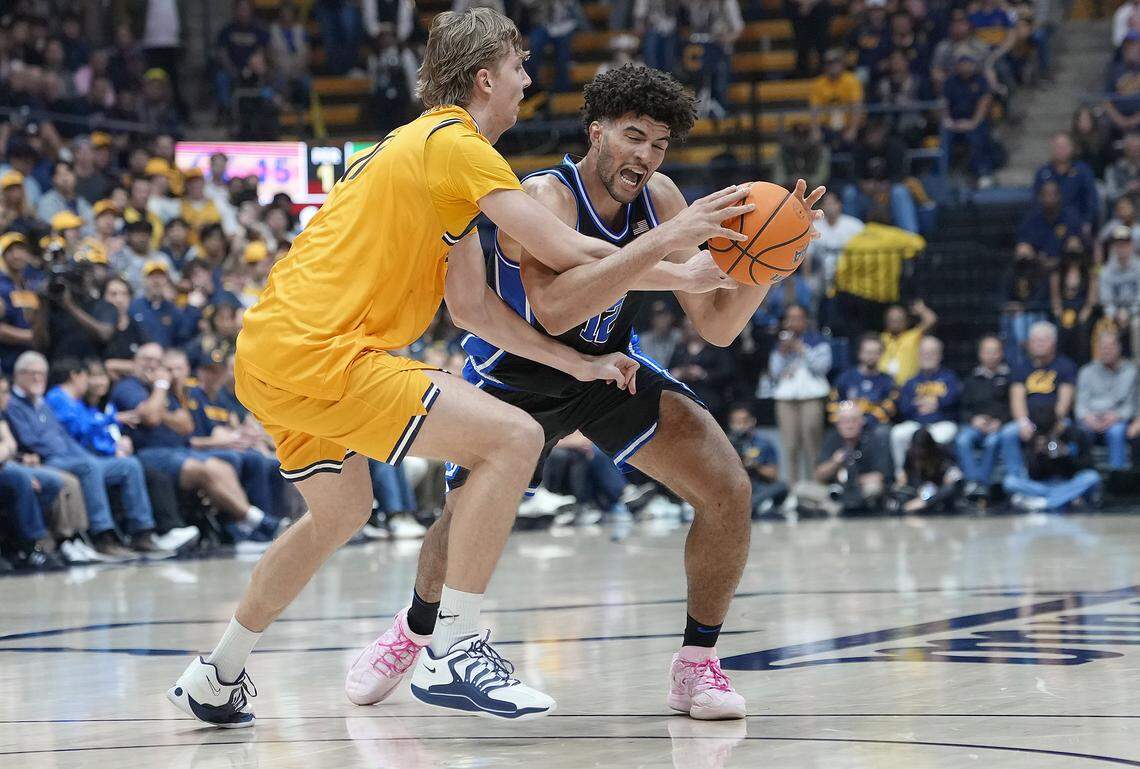 Cameron Boozer (12) of the Duke Blue Devils looking to drive to the basket gets fouled by John Camden (2) of the California Golden Bears in the first half at Haas Pavilion on January 14, 2026 in Berkeley, California.