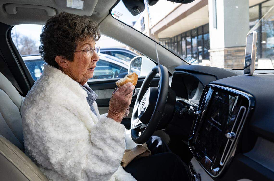 Carol Chapman, known as Grandma C, makes a TikTok on National Bagel Day tasting a bagel from New York Bagel and Deli in North Raleigh, Wednesday, Jan. 15, 2025. Grandma C said the plain bagel, lightly toasted, with olive and pimento cream cheese, is a “great bagel.”