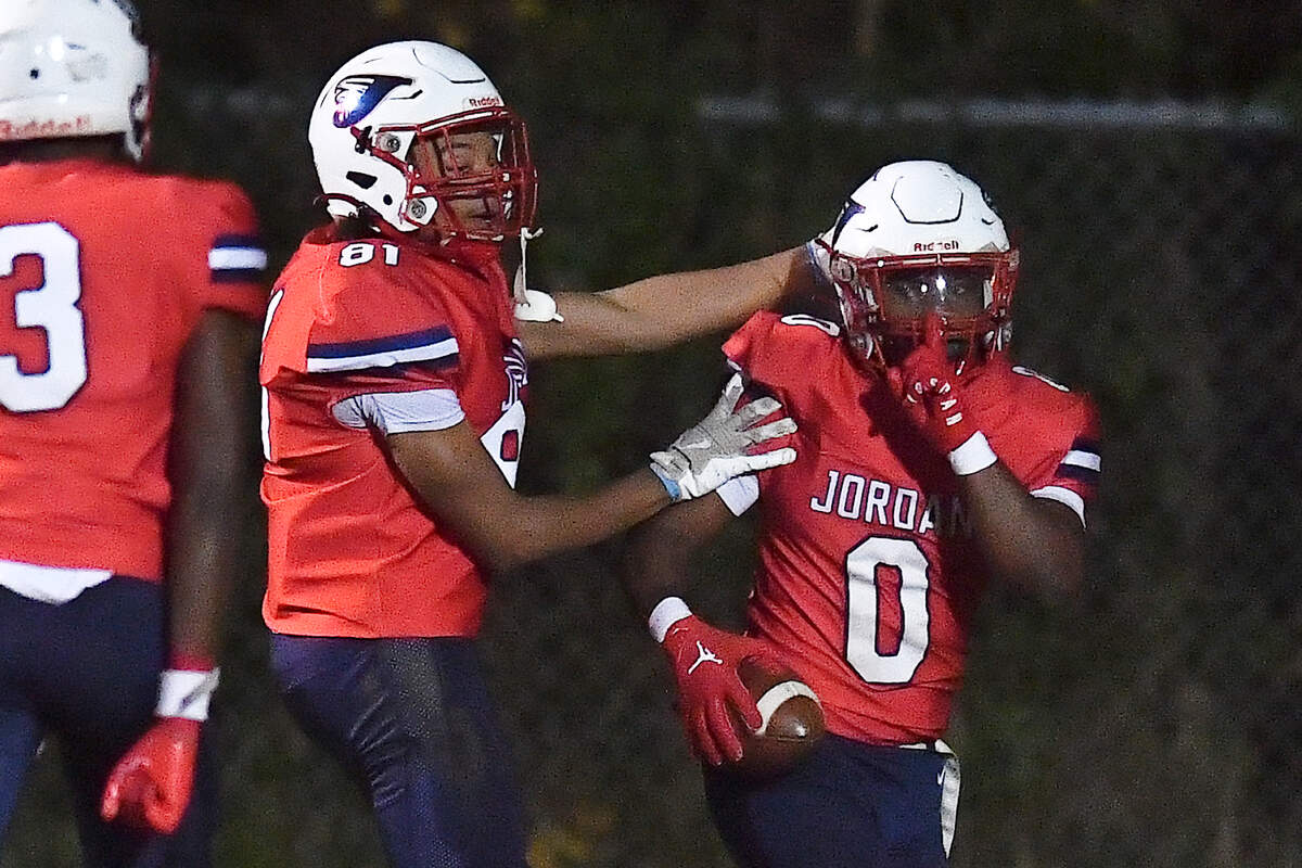 Jordan’s Amareon Blue (0) celebrates his touchdown against Apex Friendship with Marcus Martin (81) during the first half. The Apex Friendship Patriots and the Durham Jordan Falcons met in the second round of the NCHSAA 4A playoffs in Durham, N.C. on November 22, 2024.