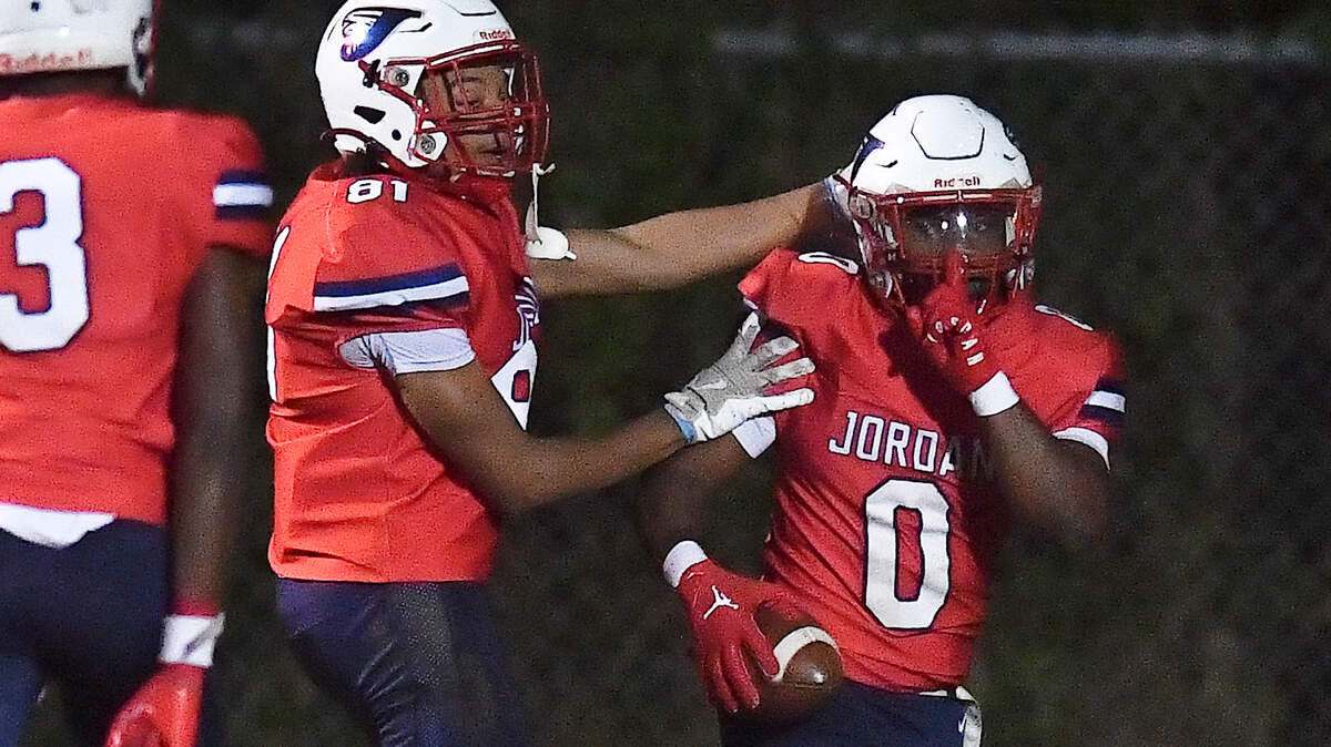 Jordan’s Amaeron Blue (0) celebrates his touchdown against Apex Friendship with Marcus Martin (81) during the first half. The Apex Friendship Patriots and the Durham Jordan Falcons met in the second round of the NCHSAA 4A playoffs in Durham, N.C. on November 22, 2024.