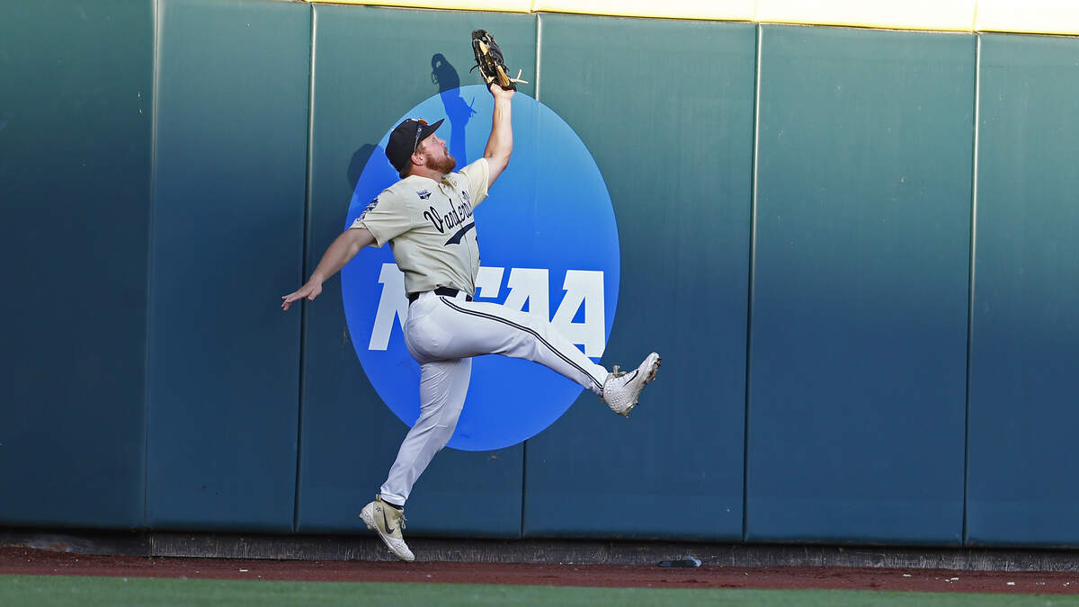 Vanderbilt’s Stephen Scott (19) catches a deep fly ball during fifth the inning in Game 3 of the NCAA College World Series baseball finals against Michigan in Omaha, Neb., Wednesday, June 26, 2019. (AP Photo/John Peterson)