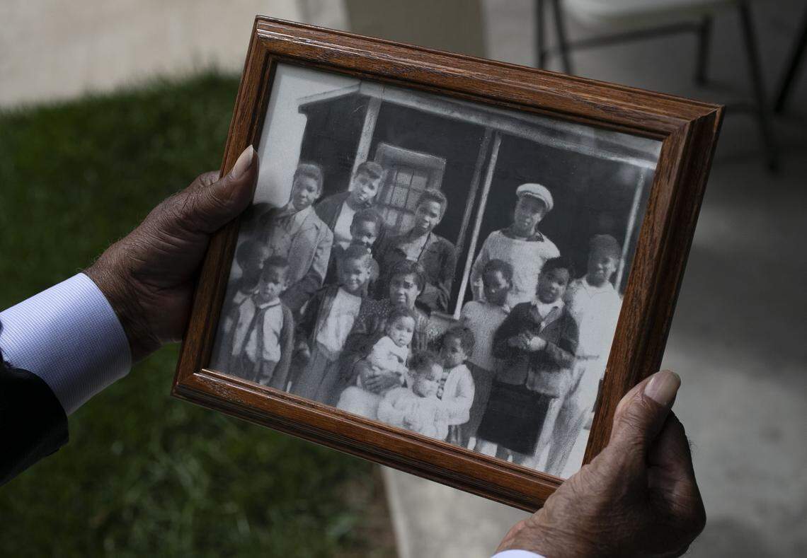 Robert Mann holds a photograph of his mother Cleora W. Mann and his siblings following her burial on Friday, May 1, 2020 in Louisburg, N.C. Mann, age 104, died from the coronavirus virus on Sunday, April 26. She was the mother of 16 children.