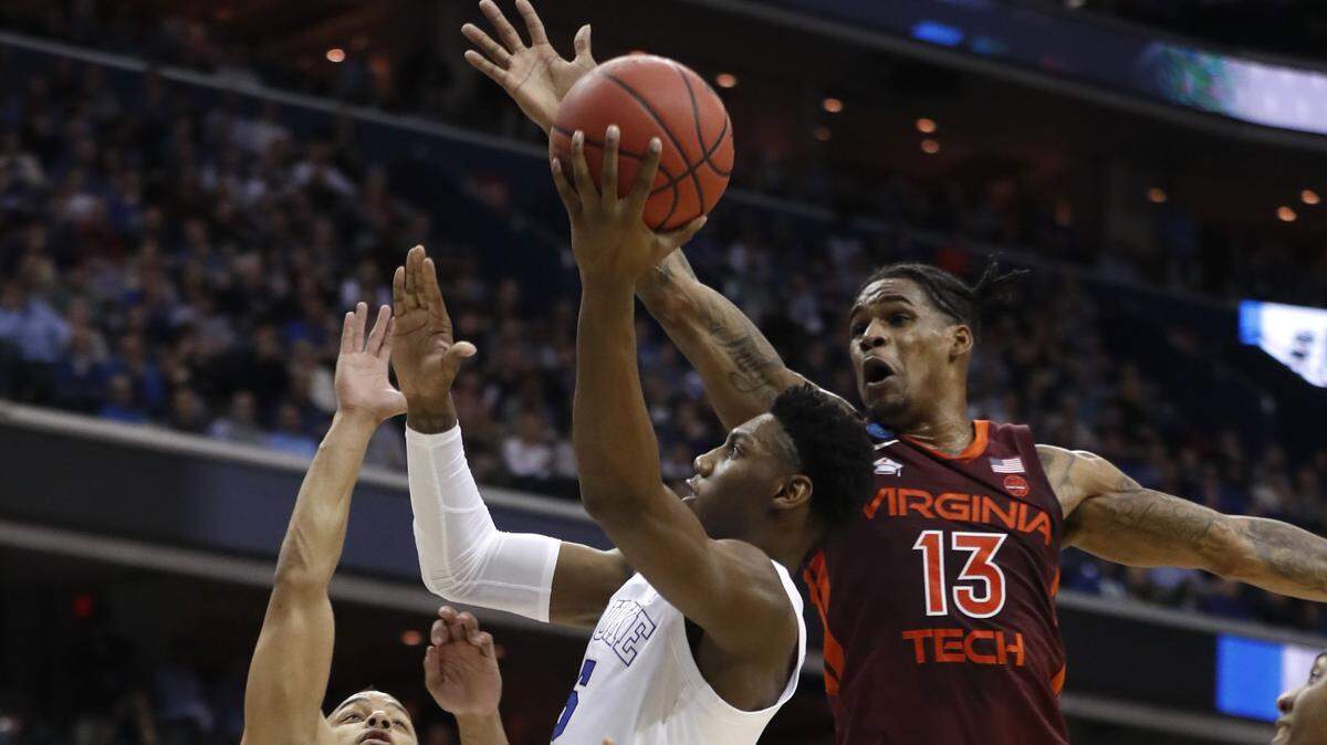 Duke’s RJ Barrett (5) drives to the basket between Virginia Tech’s Justin Robinson (5), left, and Virginia Tech’s Ahmed Hill (13) during the first half of Duke’s game against Virginia Tech in their NCAA Sweet 16 game in Washington, D.C., Friday, March 29, 2019.