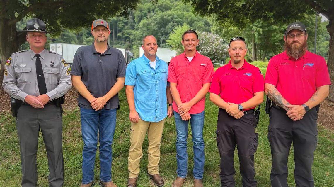 Six state employees who received the Governor’s Award for Excellence for their roles in preventing cars and trucks on Interstate 40 from falling into the Pigeon River after Hurricane Helene. They are, from left, state trooper Joe Henderson and NCDOT employees David Hall, Scottie Coggins, Austin Phillips, Garret McFalls and Christopher Strader.