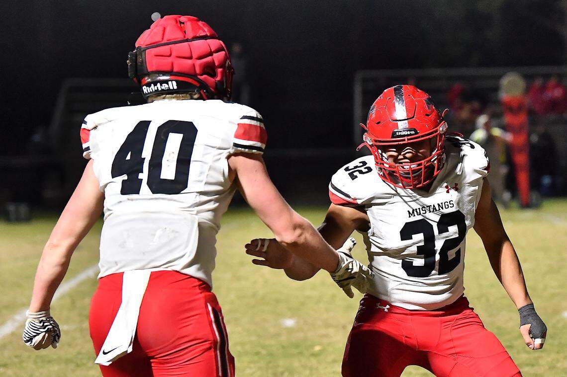 Middle Creek linebackers Edwin Mendoza Cortes (32) and Mark Smith (40) react to a play against Cary during the first half. The Cary Imps and the Middle Creek Mustangs met in a conference football game in Cary, N.C. on October 24, 2025